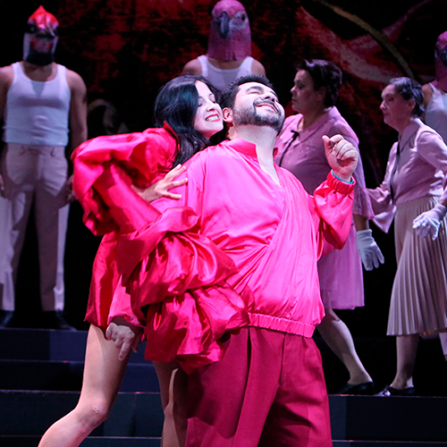 Luis performing a passionate dance in a vivid red costume during Alcina.